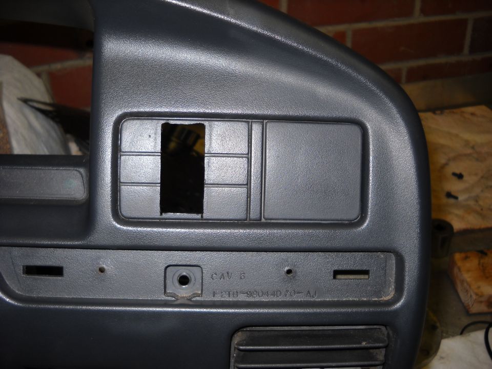Gray dashboard panel with cut-out and text F2TB-98044D70-AJ