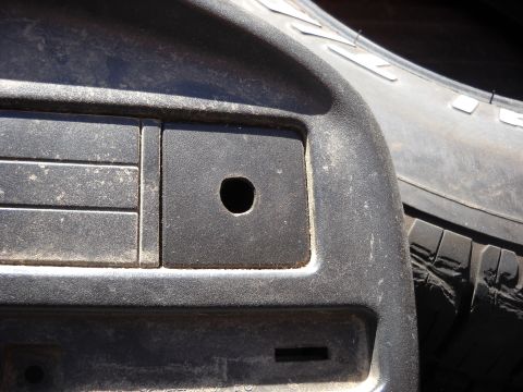 1993 Ford C-150 (Centurion Conversions) - Close-up of a vehicle's interior dashboard, showing a circular hole and a portion of a tire.
