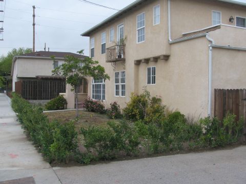 1968 Ford Mustang - A residential building with landscaping and a sidewalk in front.