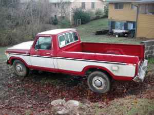1995 Ford Bronco - This is a classic Ford F-Series pickup truck, likely from the 1970s, with a distinctive red and white paint scheme.