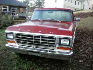 1995 Ford Bronco - This red Ford pickup truck, likely a 1979 model, is shown from the front.