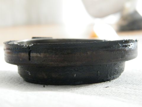1982 Ford Bronco - A close-up view shows a damaged metal component, likely a bearing or seal, with visible wear and a crack.