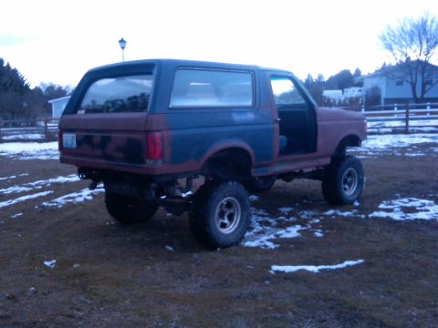 1988 Ford Bronco - This lifted Ford Bronco is missing its driver's door and appears to be in a state of repair.