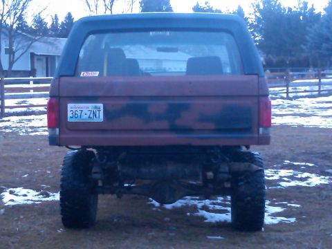 1988 Ford Bronco - This lifted Ford Bronco has a camouflage pattern on its rear tailgate and a Washington state license plate.