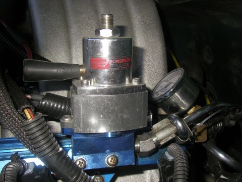 1990 Ford Bronco - A polished Professional Products Powerflow adjustable fuel pressure regulator mounted on a blue anodized fuel-rail block in an engine bay,…