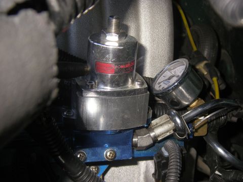 1990 Ford Bronco - Close-up of a polished aluminum Professional Products Powerflow adjustable fuel pressure regulator mounted on a blue anodized fuel rail blo…