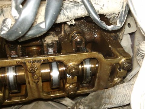 1998 Ford Crown Victoria - Close-up of an engine's valve train, revealing internal components and a part number.
