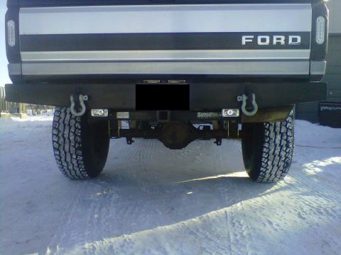 1994 Ford F-150 - This 1994 Ford F-150 features a heavy-duty aftermarket bumper with integrated tow hooks and auxiliary lighting.