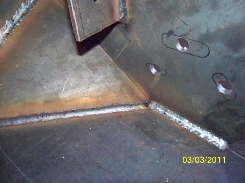 1989 Ford Bronco - This image shows a close-up view of a metal structure with visible welds and pre-drilled holes.