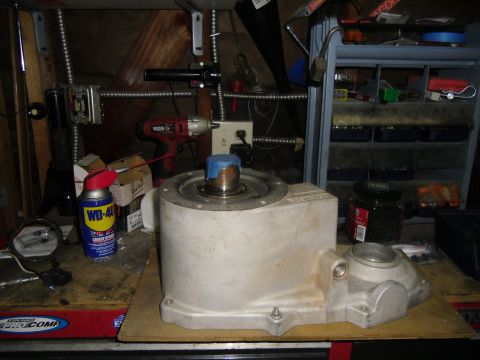 1992 Jeep Wrangler - An unidentified aluminum automotive part is shown on a workbench, surrounded by various tools and supplies.