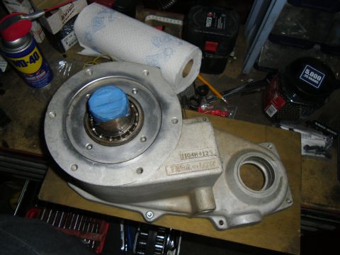 1992 Jeep Wrangler - Aluminum part with bearing and blue tape, part number 1104H4129, sits on a wooden surface with tools.