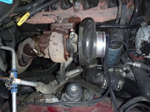 1997 Dodge 2500 - Close-up view of a turbocharger and associated engine components, including an oil filter and transmission fluid dipstick.