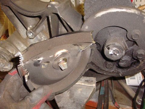 1989 Ford Bronco - A close-up view of a damaged metal part, possibly from a vehicle's drivetrain, showing broken gears and a bolt head.