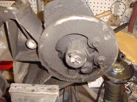 1989 Ford Bronco - Automotive part held in a vise, with an angle grinder and other tools nearby.