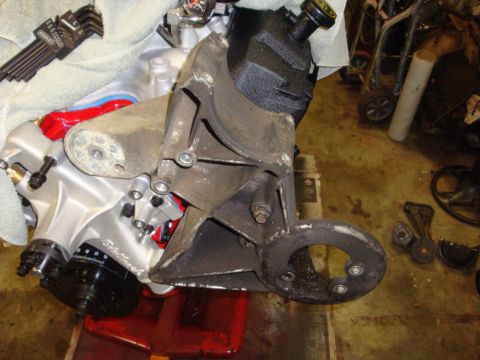 1989 Ford Bronco - Close-up of an engine component, possibly a power steering pump assembly, with tools nearby.