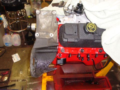 1989 Ford Bronco - Engine components are visible, including an oil cap and a mounting bracket, in a workshop setting.