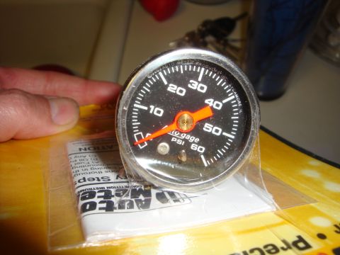 1989 Ford Bronco - Close-up of an Auto Meter oil pressure gauge, still in its packaging.