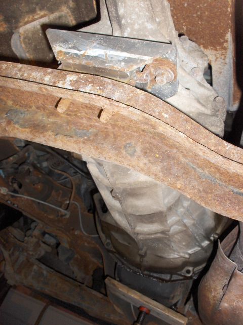 1994 Ford F-150 - The underside of a vehicle shows significant rust on the frame and various mechanical components.