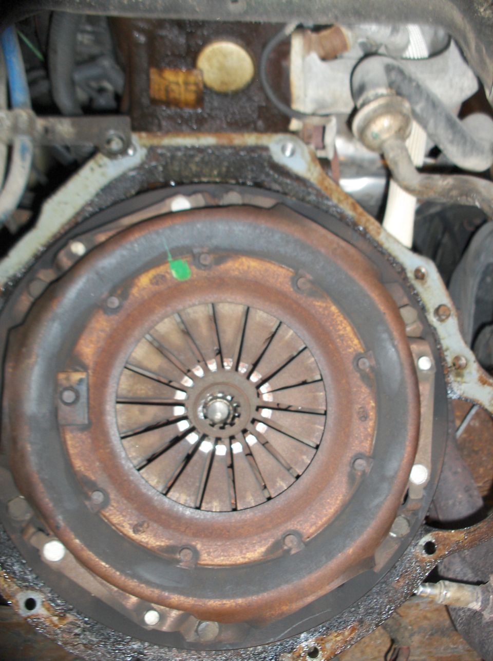 Rusty clutch and flywheel assembly with visible splines and pressure plate