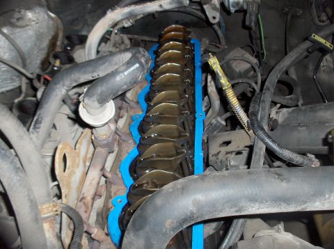 1994 Ford F-150 - The engine's valve cover gasket is being replaced, showing the internal components of the engine.