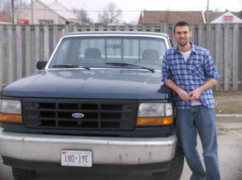 1994 Ford F-150 - 1994 Ford F-150 pickup truck with a man standing beside it.