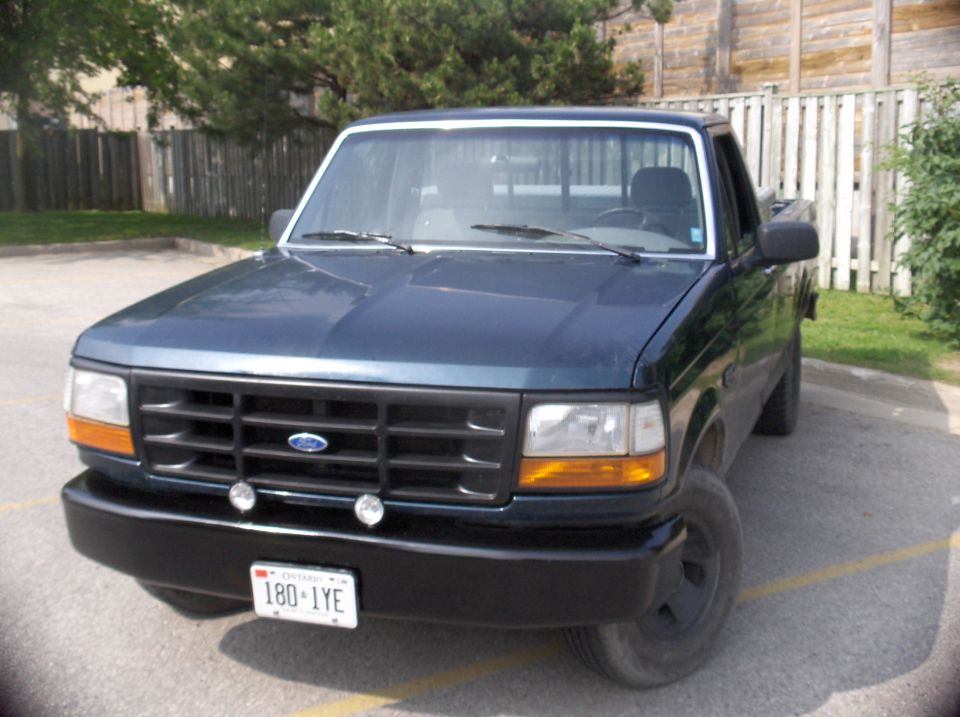 Dark blue 1994 Ford F-150 pickup truck, front 3/4 view