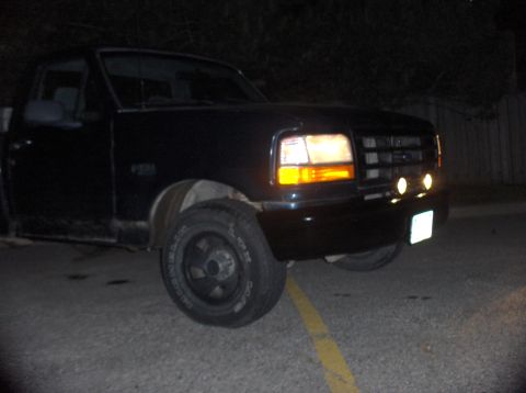 1994 Ford F-150 - This 1992 Ford F-150 is shown from the front quarter angle at night with its lights illuminated.