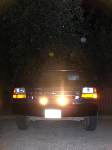 1994 Ford F-150 - Front view of a 1994 Ford F-150 truck at night, illuminated by its own lights.