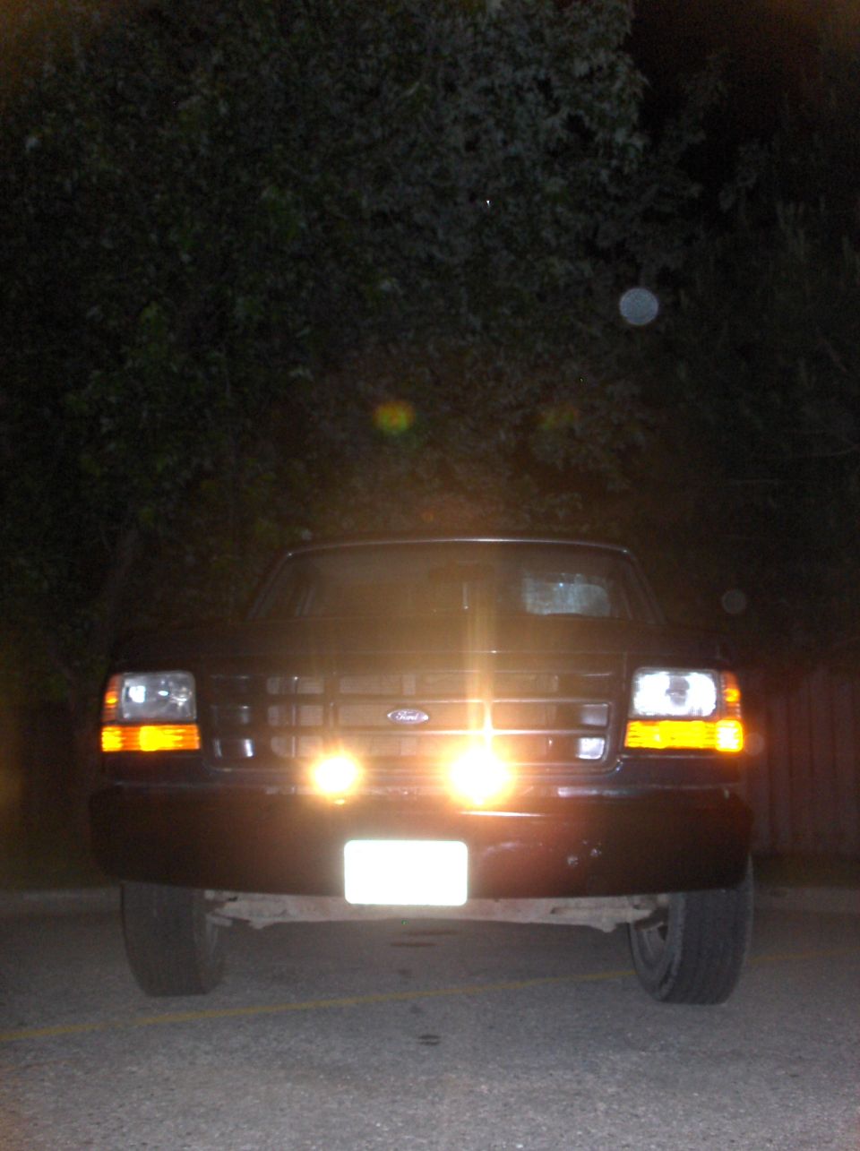 1994 Ford F-150 front view at night with headlights and fog lights on