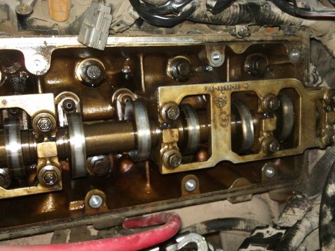1998 Ford Crown Victoria - Close-up of an engine's valve train, showing internal components and a visible part number.