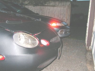 1997 Ford Taurus - The front end of a black 1997 Ford Taurus is visible, with another vehicle behind it.