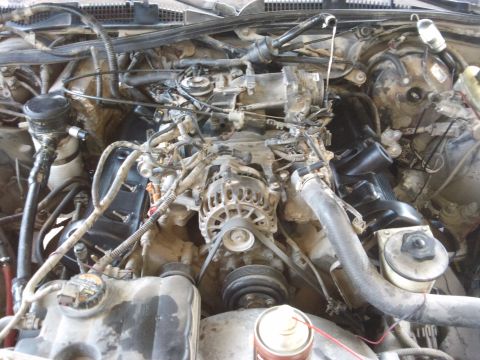 1998 Ford Crown Victoria - Close-up view of the engine compartment, highlighting mechanical components and wiring.