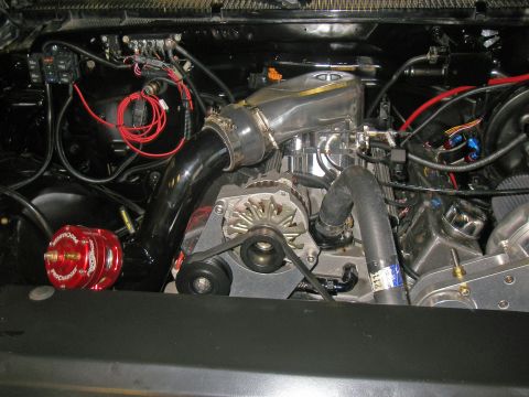 1990 Ford Bronco - Custom engine bay features a polished intake manifold, supercharger, and a red blow-off valve.