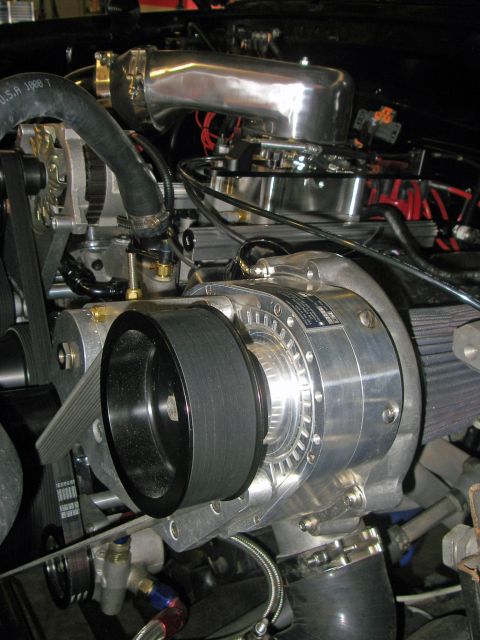 1990 Ford Bronco - Engine bay details showing a supercharger and associated parts.
