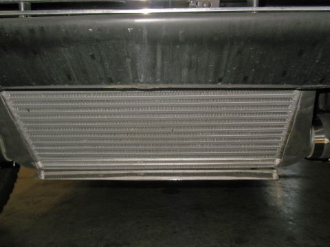 1990 Ford Bronco - Close-up view of an intercooler installed on a vehicle, positioned beneath the front bumper.