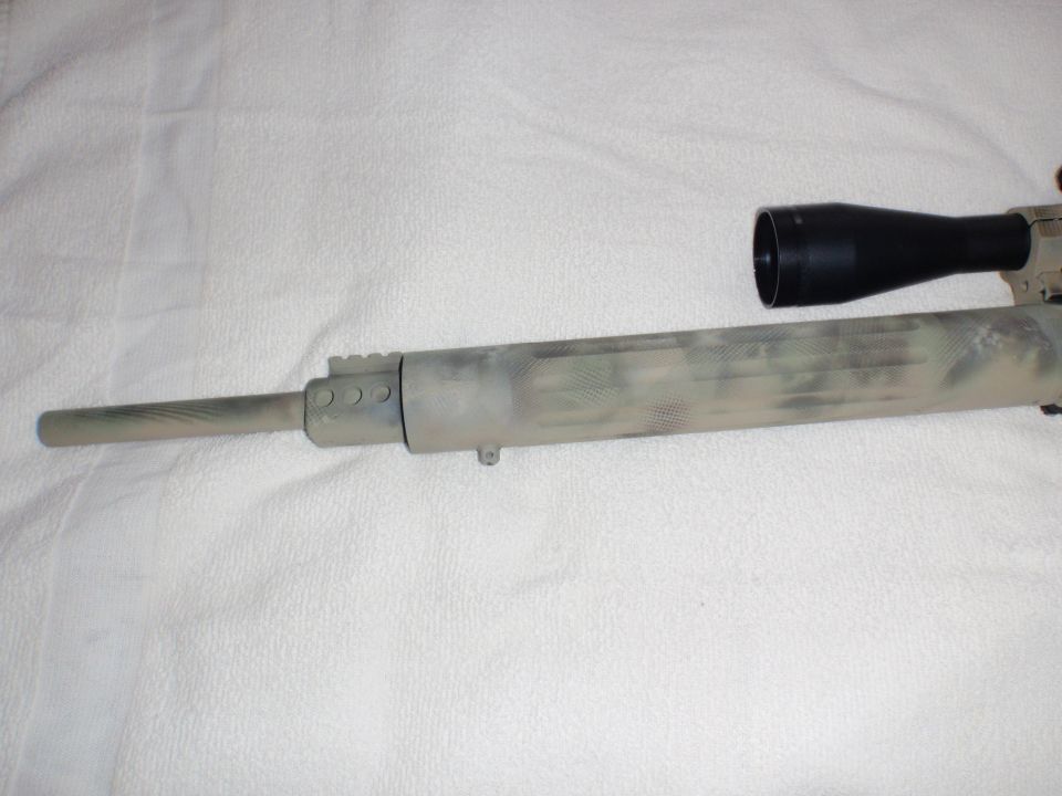 Rifle barrel with camouflage pattern and attached scope