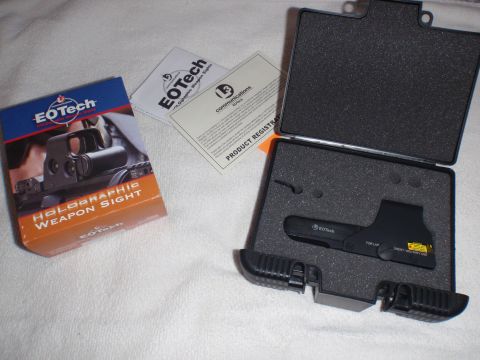 1991 Ford Bronco - An EOtech holographic weapon sight is shown with its original packaging and product registration documents.