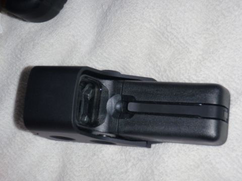 1991 Ford Bronco - A close-up view of a black plastic component, possibly a bracket or housing, with a metal clip visible.