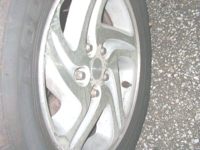 1997 Ford Taurus - A close-up view of a vehicle's wheel and tire, with a watermark indicating the source.