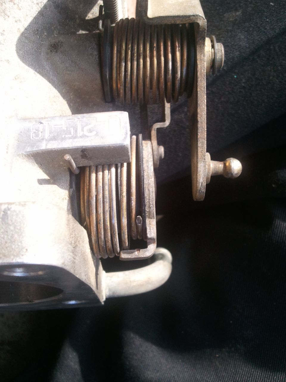 Throttle body assembly showing springs and linkage