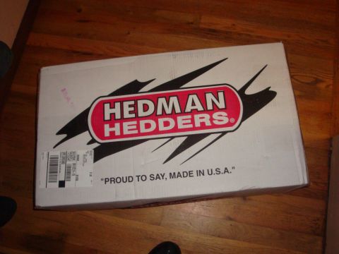 1989 Ford Bronco - A Hedman Headers box sits on a wooden floor, displaying the brand's logo and a "Made in U.S.A." statement.