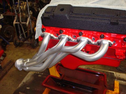 1989 Ford Bronco - Engine block and exhaust headers are shown in a workshop setting.