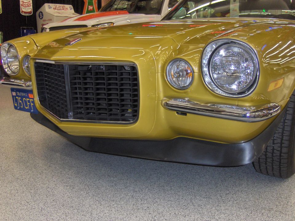 Gold Chevrolet Camaro front end with black grille and chrome bumper. California license plate 475 CFF visible