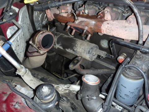 1997 Dodge 2500 - Close-up view of a vehicle's engine compartment, focusing on the turbocharger and exhaust system components.