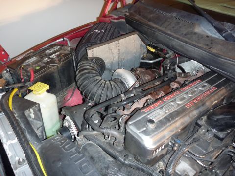 1997 Dodge 2500 - The engine bay of a 1997 Dodge 2500 is visible, the turbocharger and a large intake hose.