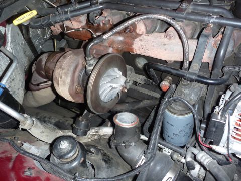 1997 Dodge 2500 - Close-up view of a turbocharger and associated engine plumbing, likely from a diesel truck.