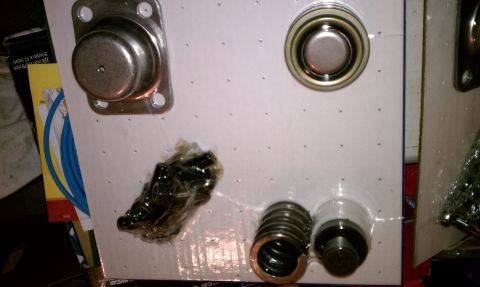 1990 Ford Bronco - Various automotive parts are displayed in their packaging, ready for installation.