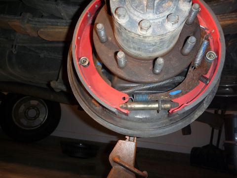 1997 Dodge 2500 - Vehicle brake drum assembly with new red brake shoes and springs visible.