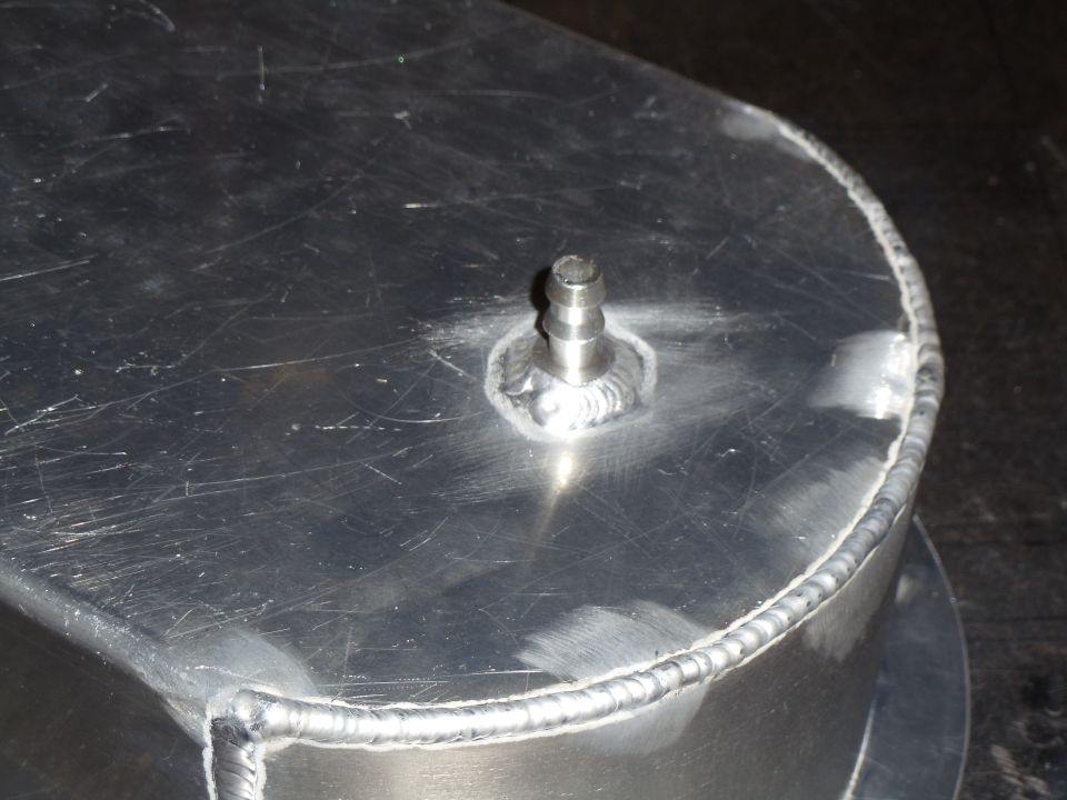 Aluminum part with barbed fitting and visible welds