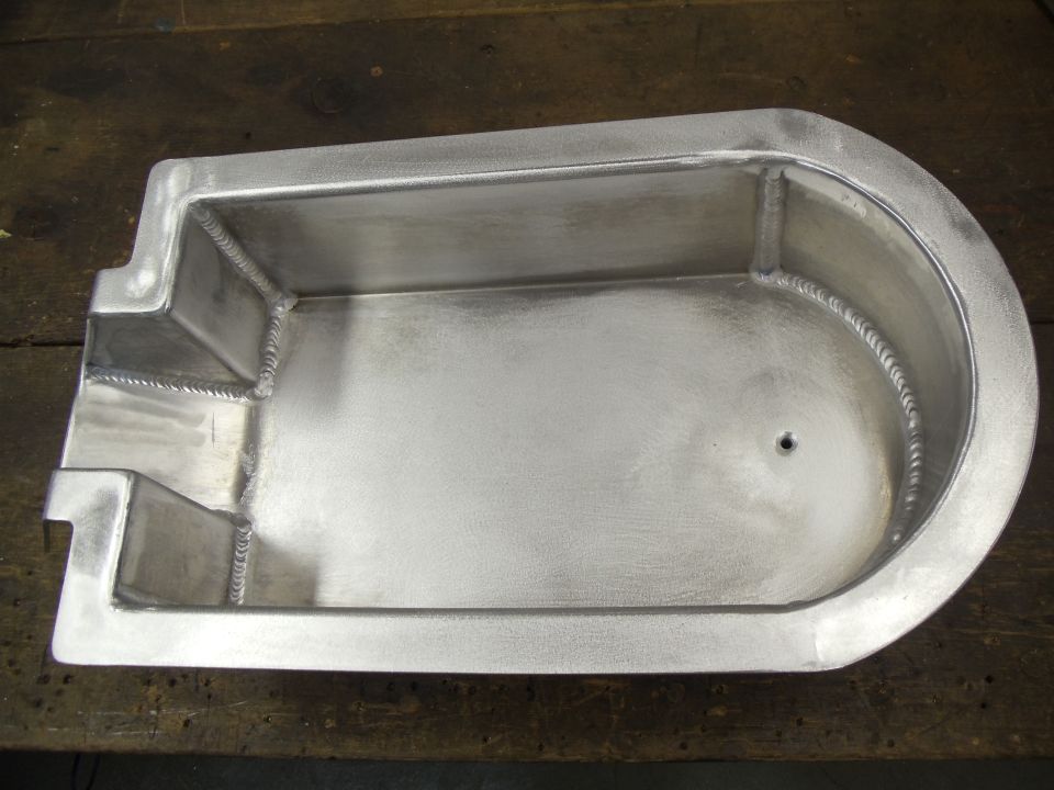Aluminum foot control tray with welded seams and a drain hole